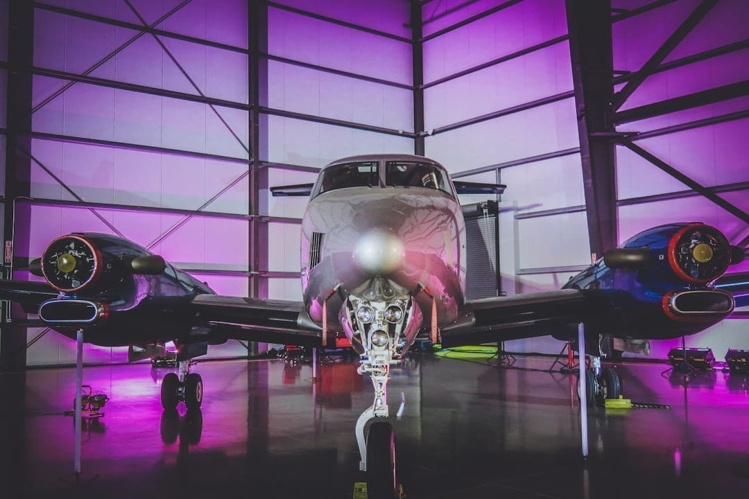 Elegant charity gala in aircraft hangar with private jets as backdrop
