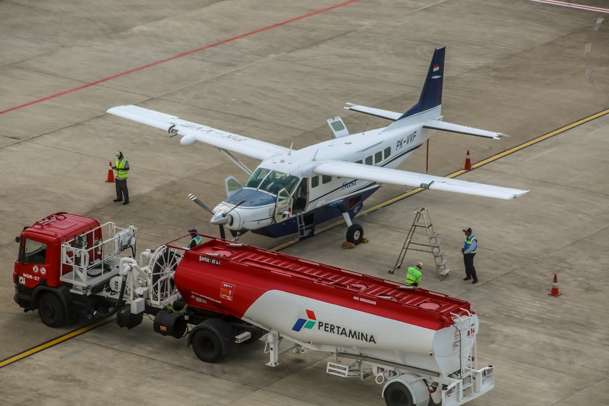 A small aircraft being refueled on an airport tarmac