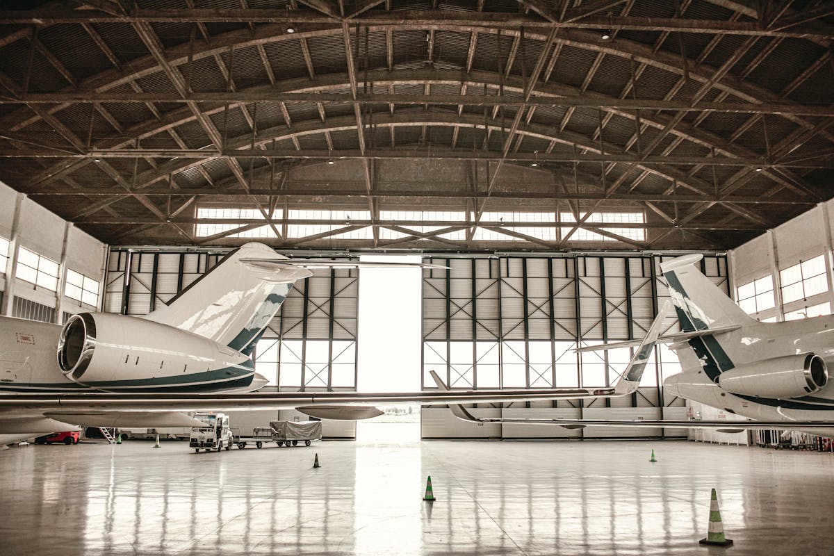 Private jets parked inside a large hangar