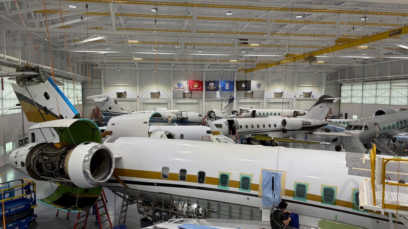 Business jets stacked wing to wing in a Duncan Aviation maintenance hangar