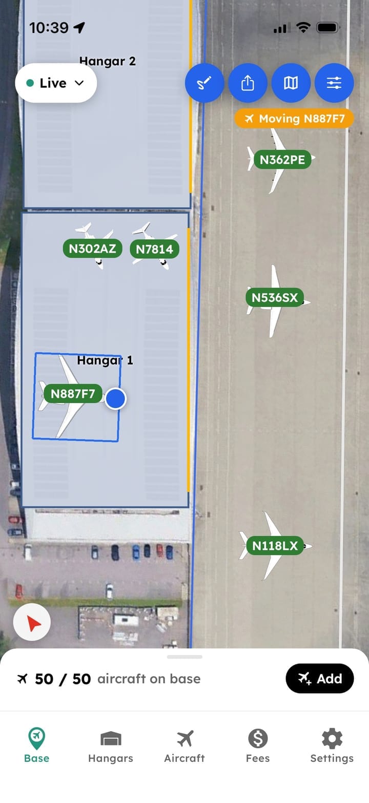 AirPlx Base View on a phone, zoomed to one hangar and the ramp beside it: the aircraft inside the hangar and out on the ramp each labeled with its tail number, with N887F7 selected